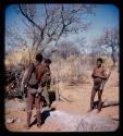 Hunting: Two men with hunting equipment and a woman standing by a skerm