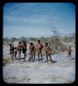 Hunting: Group of men, including ≠Toma and Gao, standing with hunting equipment