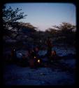 Groups: Group of people sitting by fire