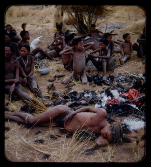 Hunting, Ostrich: Hunting, Ostrich: "/Qui Hunter" sleeping after an ostrich hunt, with other people sitting behind him