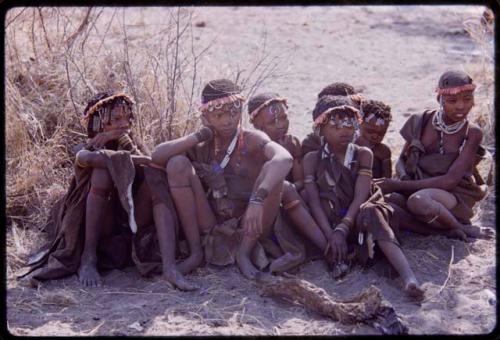 Girls sitting, wearing aloe wreathes