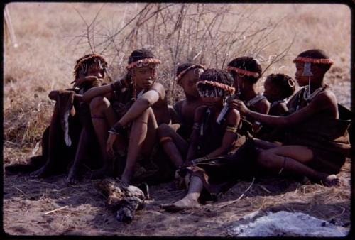 Girls sitting, wearing aloe wreathes