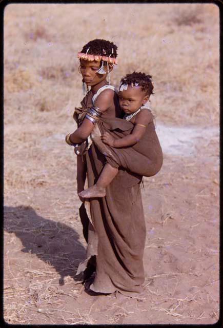 Girl carrying a baby on her back