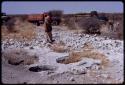 Man standing by pits, expedition trucks in the background