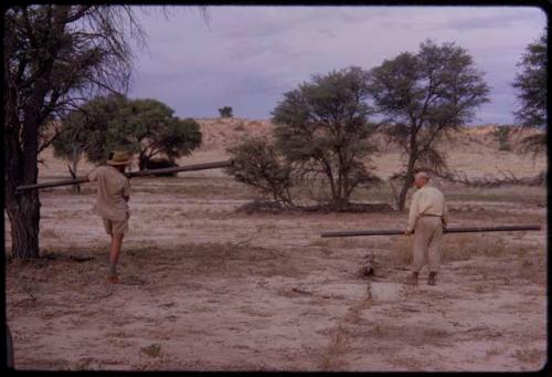 Wulf Haacke and O.P.M. Prozesky carrying metal poles