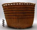 Very thin basket with wool woven on sides for design