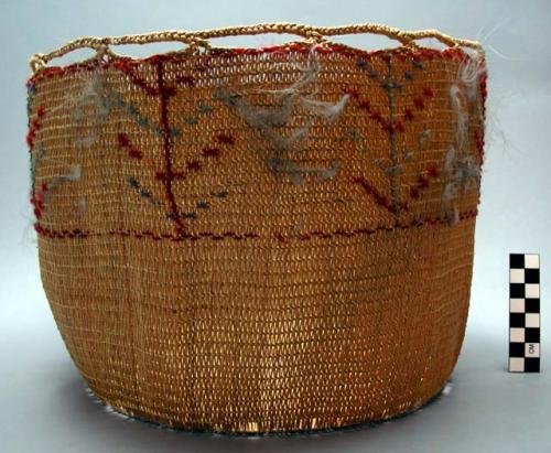 Basket w/ red & blue wool imbrication, feather down entwined in upper portion.