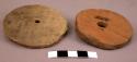 2 pottery discs, one restored, with center holes