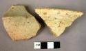 Rim potsherd; shoulder sherd - cream slipped, well polished coarse sherds