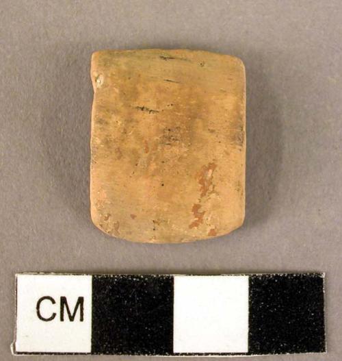 Pottery handle fragment - red glazed, badly worn