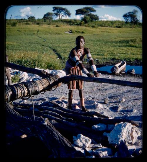 Makiena (wife of Muremi) standing and getting water at a waterhole