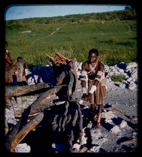 Makiena (wife of Muremi) standing and getting water at a waterhole