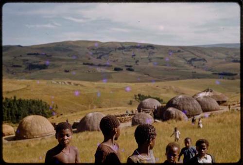 Children with a village in the background