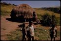 People standing by a hut