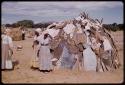 Women standing by a hut