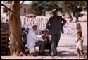 Elderly man and others at a well