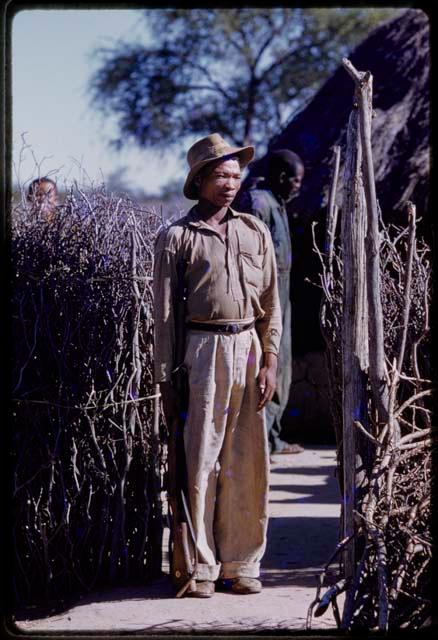 Boys standing in front of his house