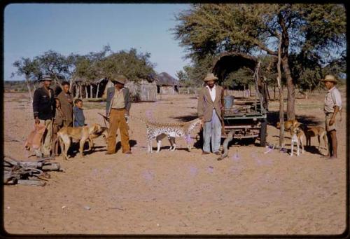 Two people holding a leopard skin