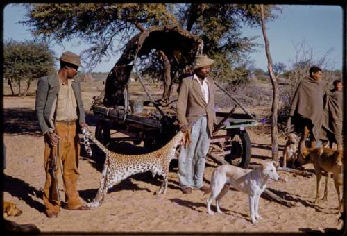 Boys and his brother holding up a leopard skin