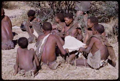 Group of people working on an animal skin