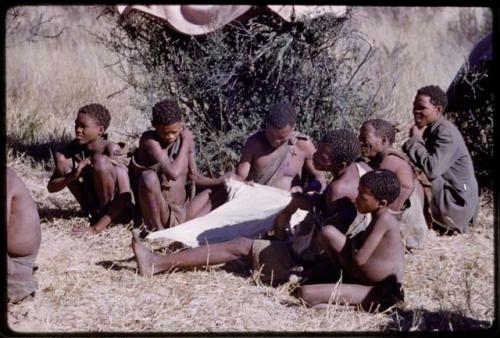 Group of people working on an animal skin