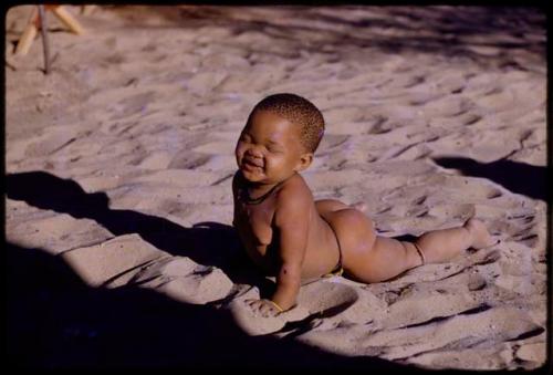 Child lying in the sand