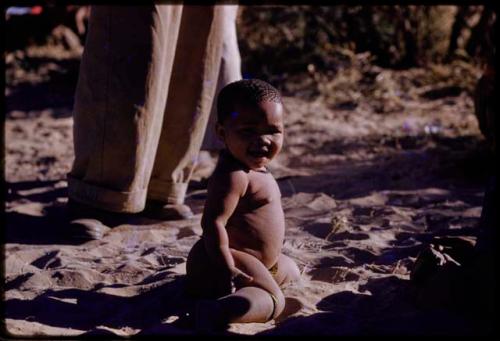 Child kneeling in the sand