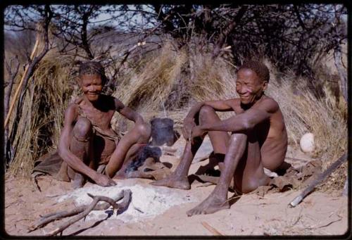 Ngani and his wife sitting by their fire