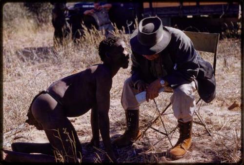 L. F. Maingard listening to a man and recordings clicks