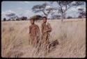 Two men standing in the grass