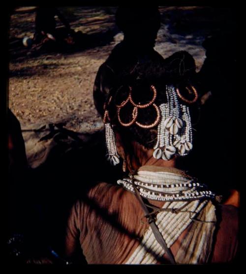 Ornament: Woman's hair showing many beads