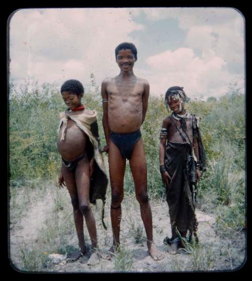 Portraits: "/Gao Music" standing with his wife, ≠Nisa, and his son, /Qui