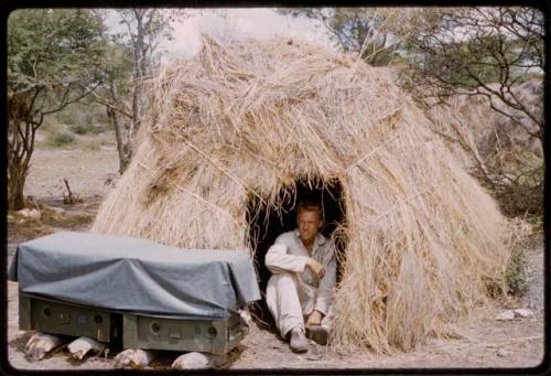 John Marshall sitting in his skerm, with sound equipment in the foreground