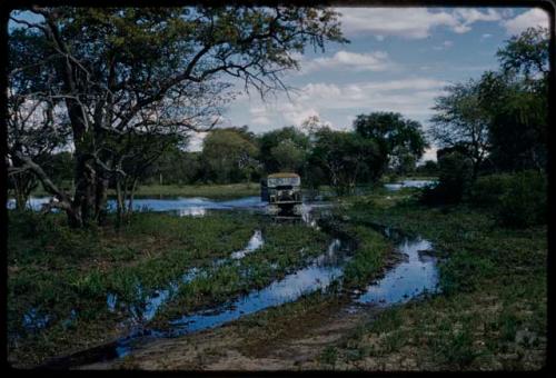 Pan filled after rain, with a truck in a rain-filled track