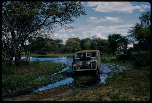 Pan filled after rain, with a truck in a rain-filled track