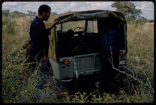 Expedition members near Land Rover