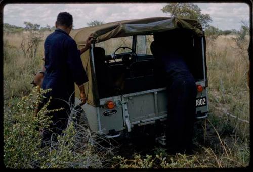 Expedition members near Land Rover