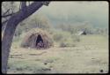 Family sitting in front of a skerm in rainy season