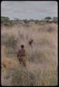 Two women standing in grass