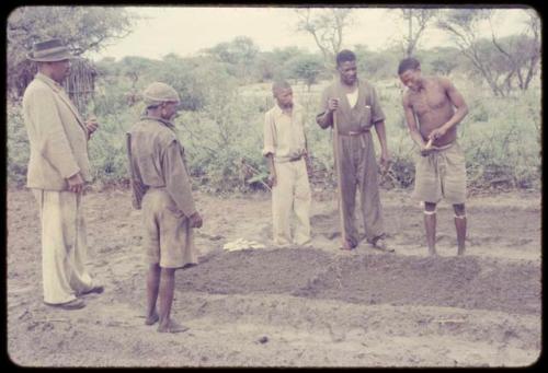 Wilhelm Camm standing with four men clearing a garden; one of them is /Ti!kay