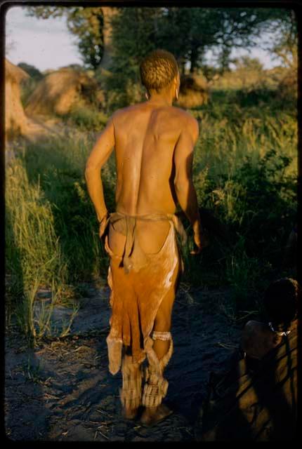 Man performing a curing dance, seen from behind