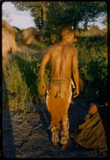 Man performing a curing dance, seen from behind