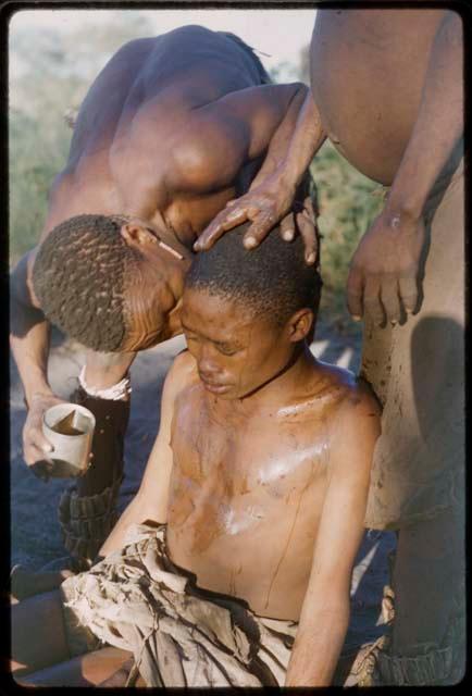 /Ti!kay blowing in /Gunda's ear during treatment