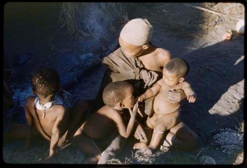 Woman sitting with three children