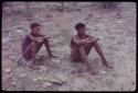 Two boys sitting on the ground