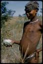 Young man holding gemsbok cucumber in his hand