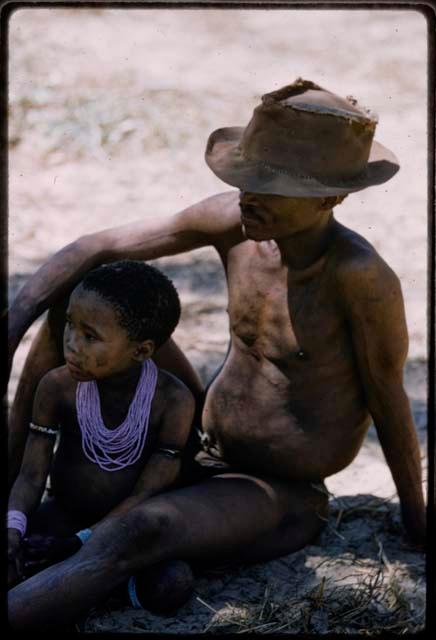 Bo wearing a hat and sitting with his daughter