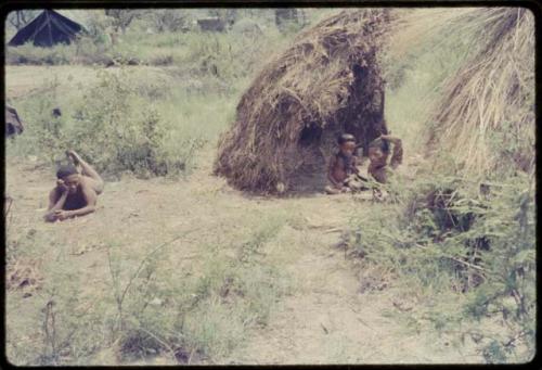 ≠Toma with a child in his skerm, with Gao lying on his stomach nearby