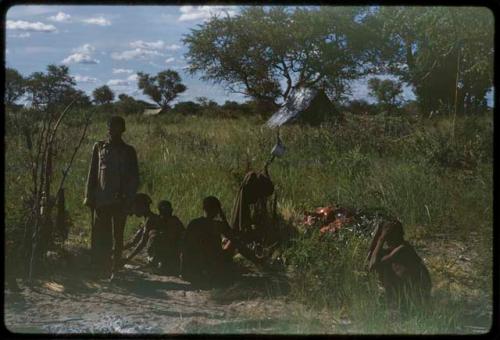 Group of people gathered, with a tent in the background