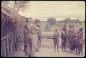 Laurence Marshall speaking with a group of people by a cookhouse